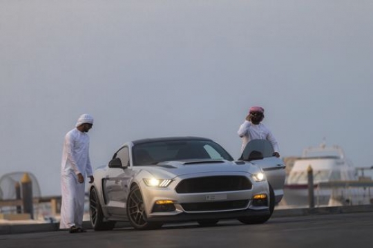 Middle eastern men exiting the luxury car|-