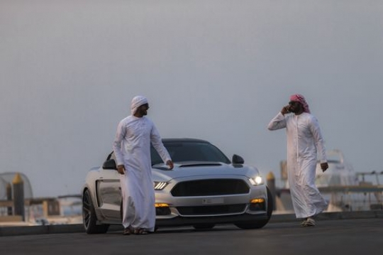 Two arab men moving away from the luxury car|-