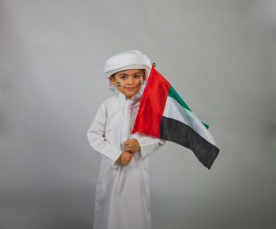 Little boy waving with flag