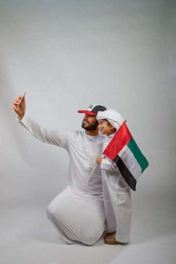 Father and Son taking a Selfie for National Day