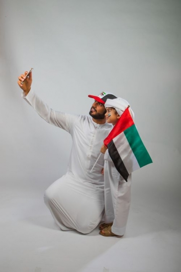 Father and Son taking a Selfie for National Day