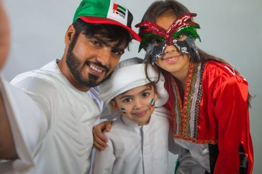 Arab family taking a picture together celebrating National Day