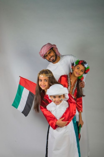 Middle Eastern Family taking a photo together for National Day