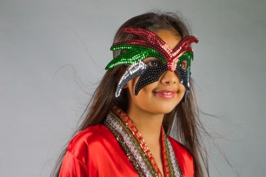 Medium shot of an Arab girl wearing a UAE colored mask