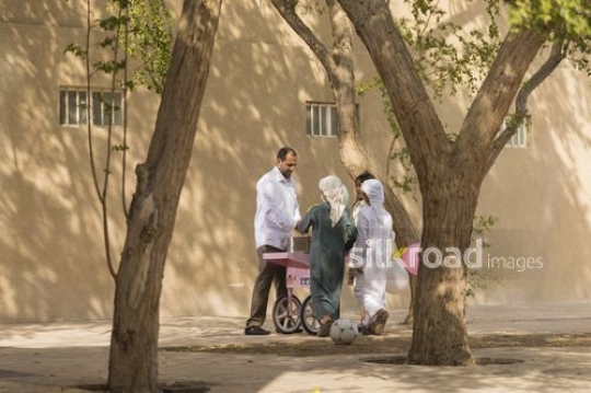 Arab kids getting cotton candy from the man|-