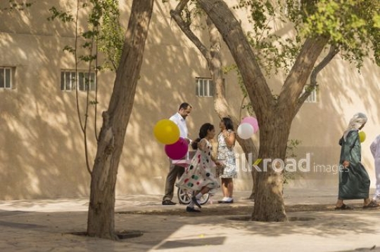 Middle Eastern kids eating candy playing around|-