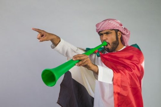 Arab man celebrating with the horn