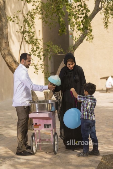 Arab mother getting her son cotton candy|-