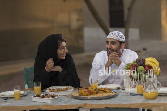 Arab man and woman sitting together on the dinning table|-