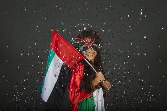 Young girl excited celebrating the UAE National Day