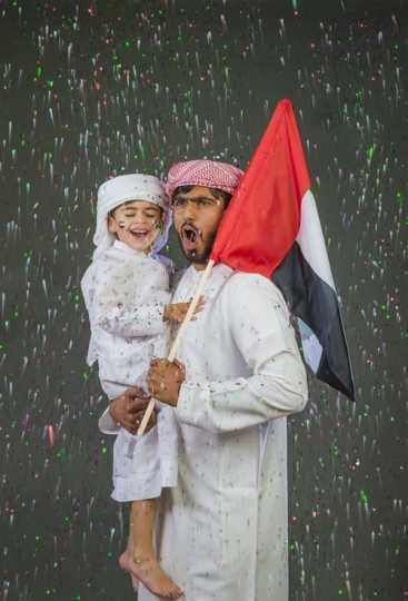 Middle Eastern man and kid celebrating their country