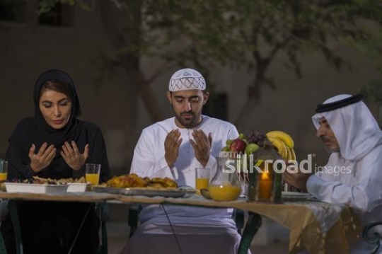 REPLACE - Arab family praying together before Iftar|-