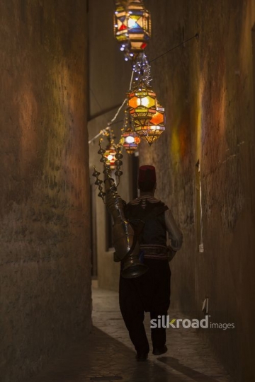 Middle Eastern Ramadan drink seller strolling through the alley|-