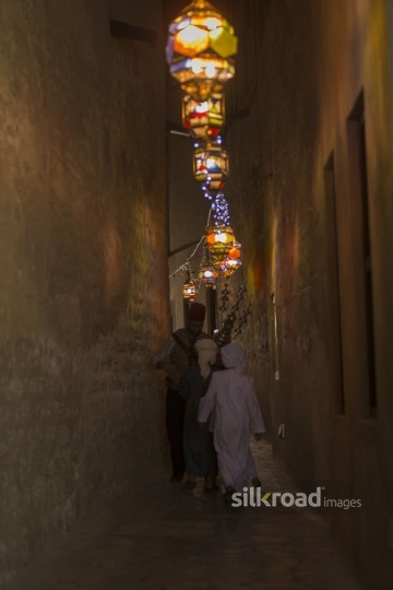 Middle Eastern Ramadan drink seller offering kids some juice|-