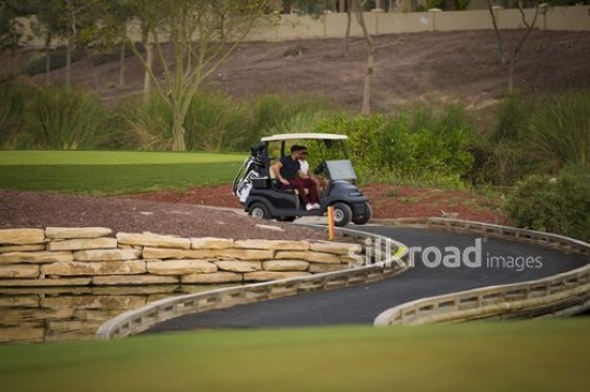 Middle Eastern men sitting together on the Golf Cart|-