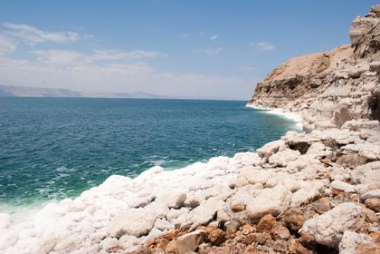 Crystalic salt on a rocks near beach in the Dead Sea, Jordan