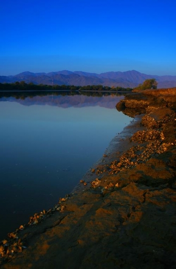 big pond with mountains in the background