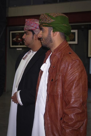 Omani men at an exhibition