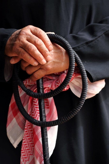 Old Arab man Resting on Cane