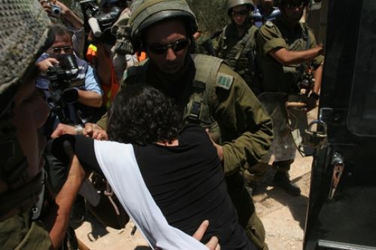 israeli soldier arresting woman