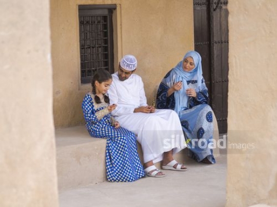 Family in conversation outside|-