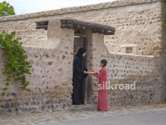 Girl sharing meal with neighbor|-