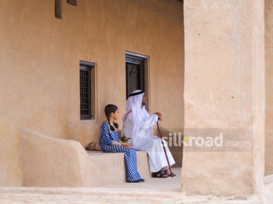 Grandfather sitting with granddaughter|-