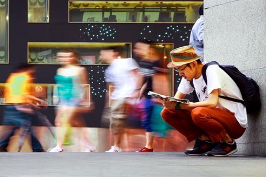 malaysian man reading the news
