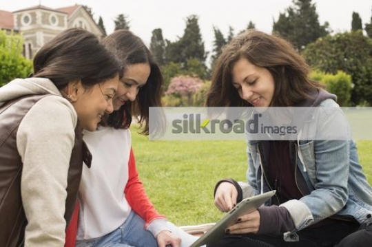 University students sitting together outside|