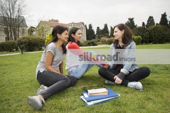 Friends sitting together talking|