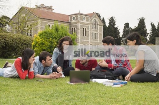 Friends sitting together on campus|