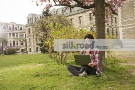 Woman sitting alone on her laptop|