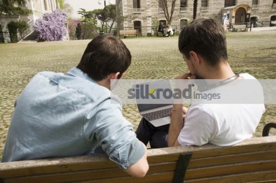 Two friends sitting on the bench together|