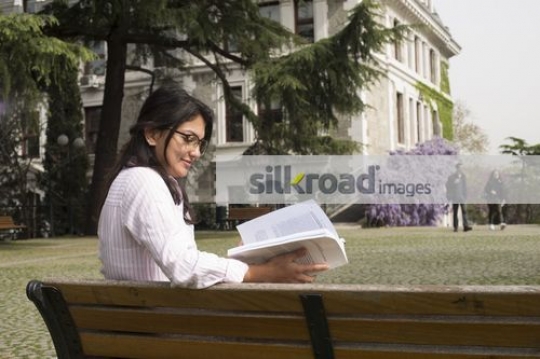 European Student sitting on the bench studying|