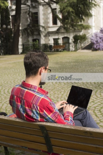 Man sitting on the bench studying|