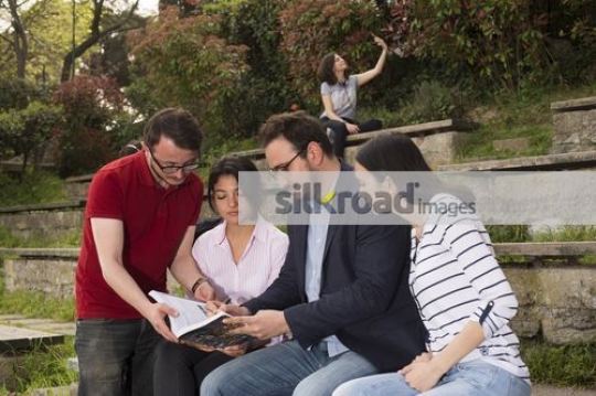 Friends sitting together talking to the professor|