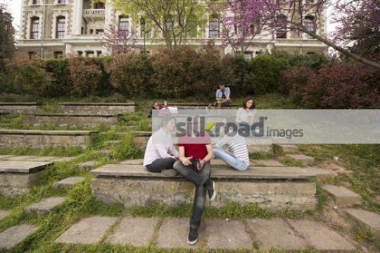 Three students sitting together bonding|