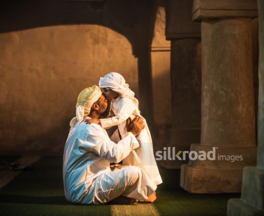 Boy kissing grandfather at the mosque|-