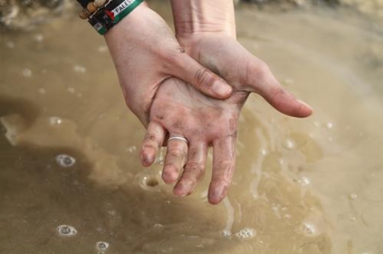 Palestinian demonstrators wash