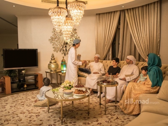 Boy serving Arabic coffee|-