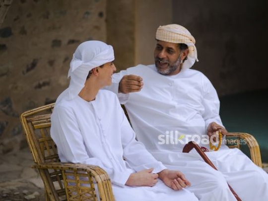 Grandfather chatting with boy|-