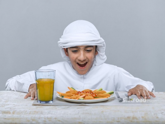 Young boy excited to eat