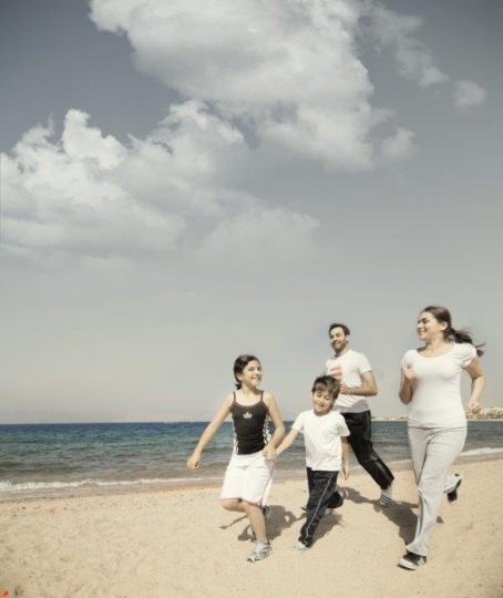 Family Running by the Sea