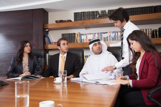 group of business people analyzing and discussing during a working meeting