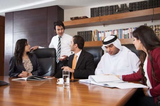 group of business people analyzing and discussing during a working meeting