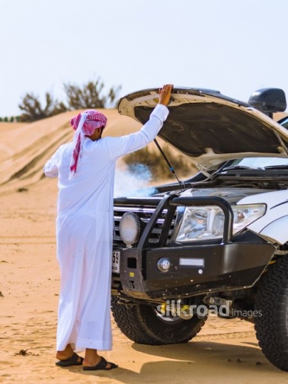 man opening car trunk