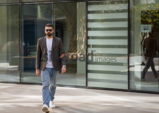 Close-Up of a Professional Man Exiting a Corporate Building