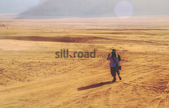 Couple Exploring the Vast Desert Landscape of Wadi Rum Jordan