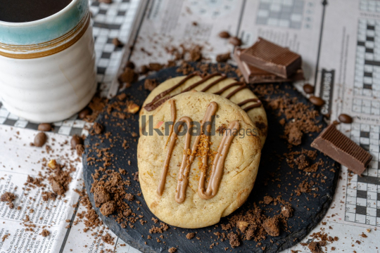 Cup of Coffee and Chocolate on Newspaper Games Page