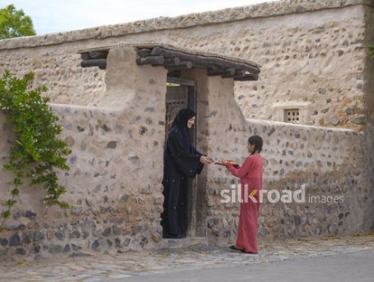 Girl sharing meal with neighbor|-